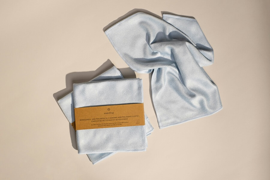 Folded microfibre cloths on a wooden surface in daylight, the free Clean Home basic