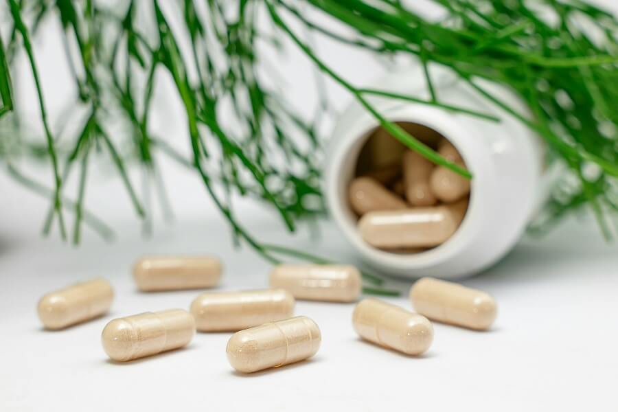 Single amber glass bottle on a linen surface in daylight, choosing a transparently-dosed stress supplement