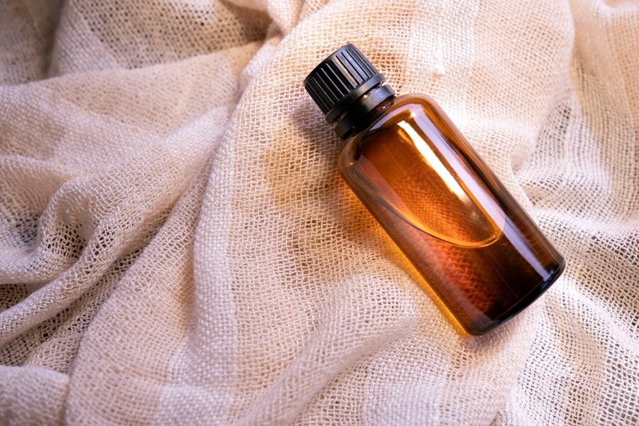 Amber lavender essential oil bottle in natural light, a pure aromatherapy pick for reducing stress
