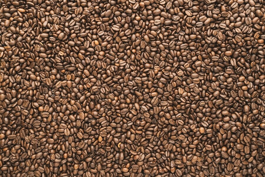 Coffee beans and a ceramic cup in morning light, fair-trade sourcing for Eat Well