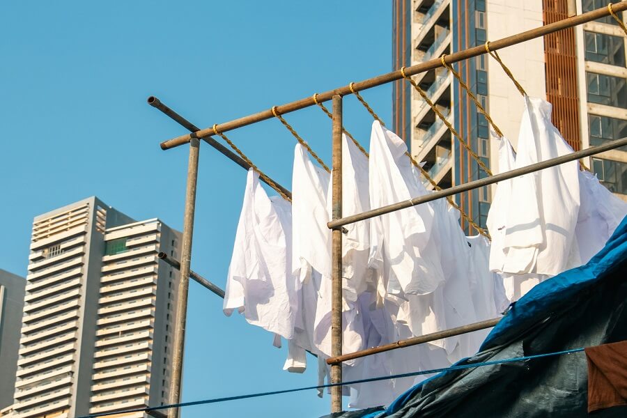 Organic cotton clothing drying on a line in natural daylight.