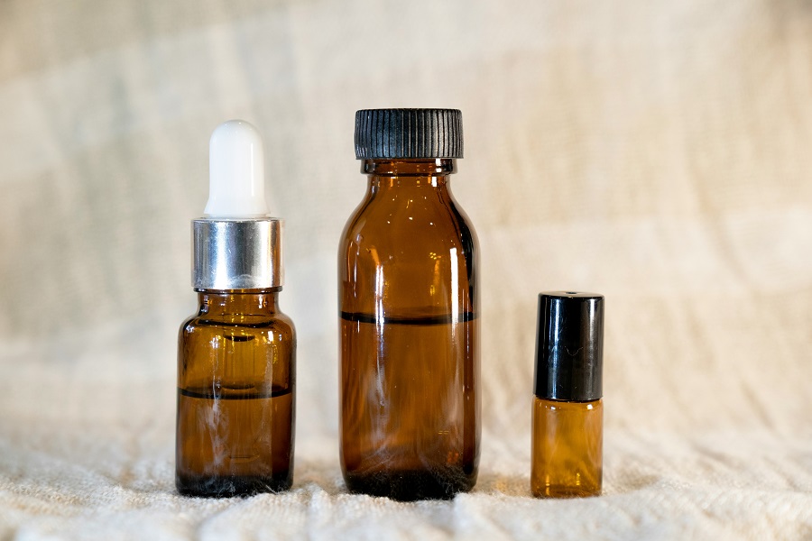 Close detail of a reed diffuser oil bottle in natural light