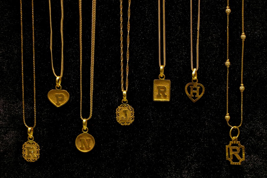 Close detail of a gold necklace showing the metal, in natural light