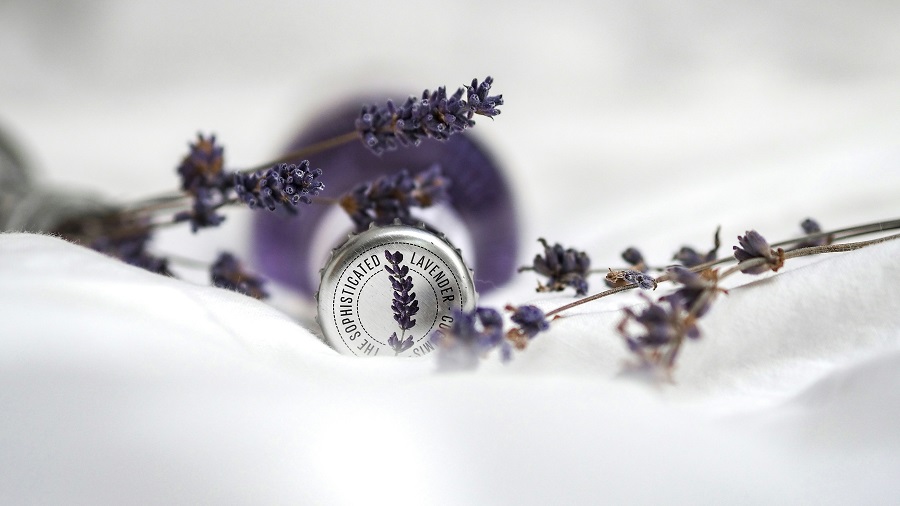 A lavender pillow spray and candle wind-down cue in soft evening light