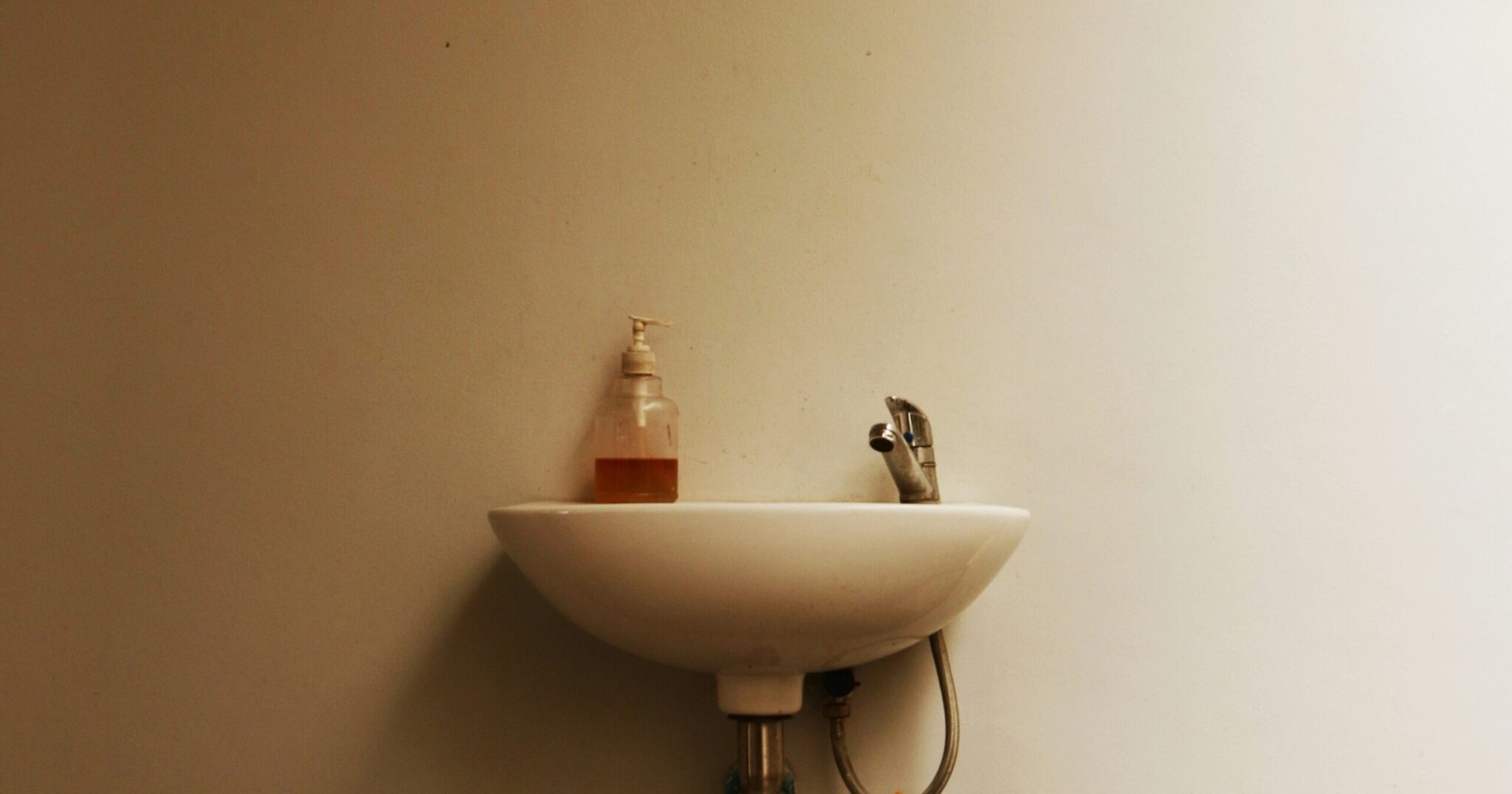 Bathroom basin in early daylight, where washing the skin beneath a beard happens
Why this image: The section is about a habit rather than a product, so the slot needs the setting the habit happens in, empty of people